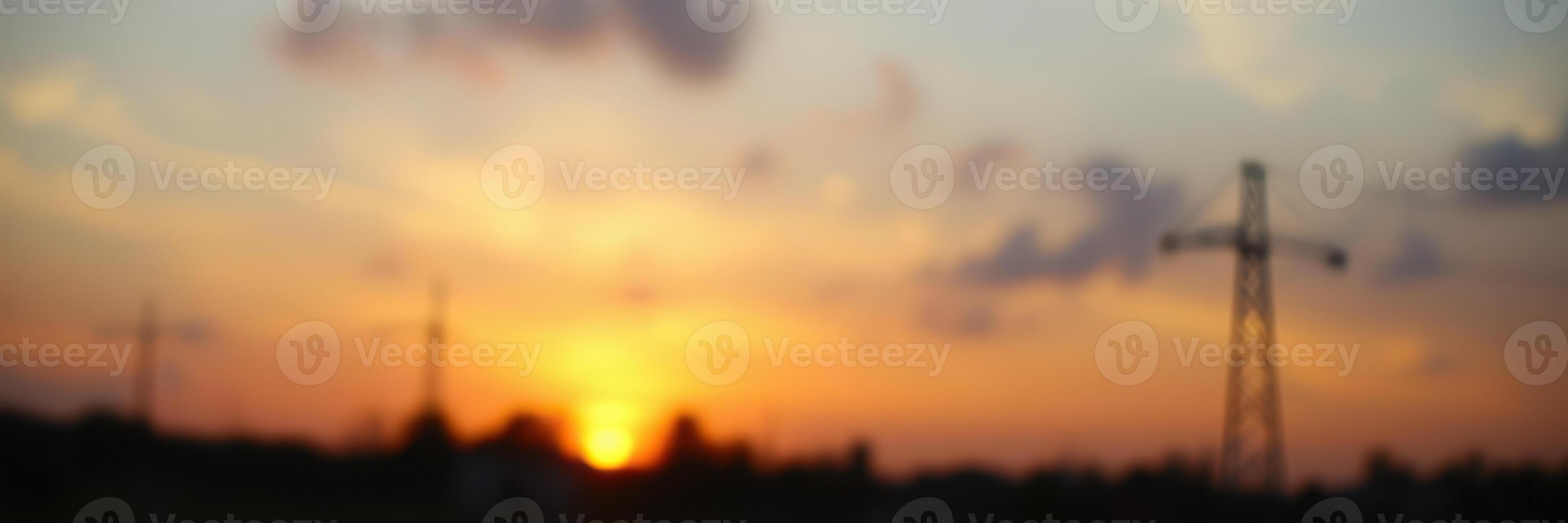 Sunset view with power lines silhouetted against a colorful sky in a rural area photo
