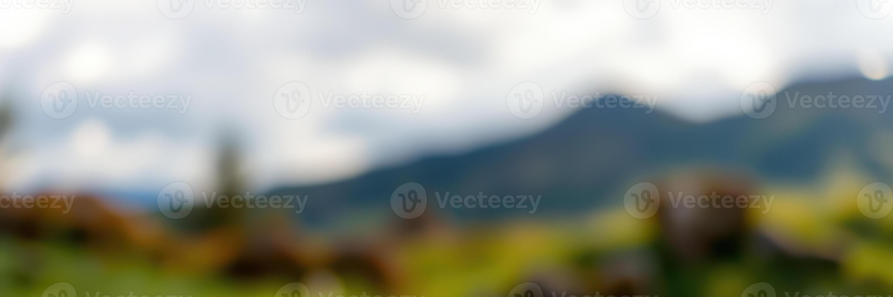 Stunning view of green hills and mountains under a cloudy sky captured during a serene afternoon photo