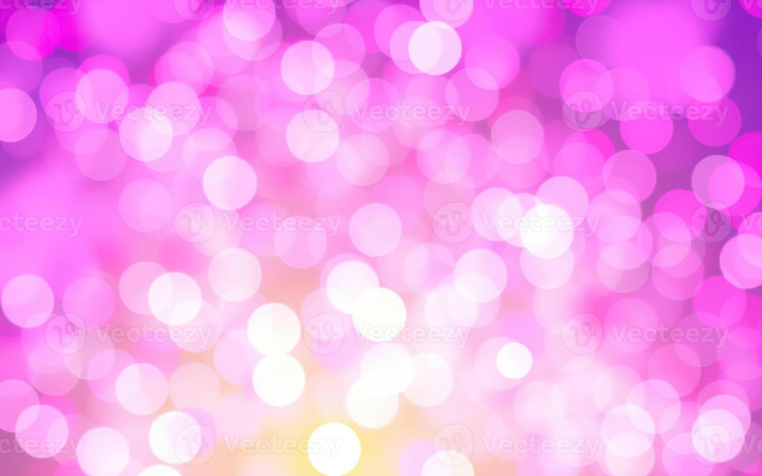 Colorful abstract background with luminous bokeh lights in shades of pink and yellow during an evening event photo