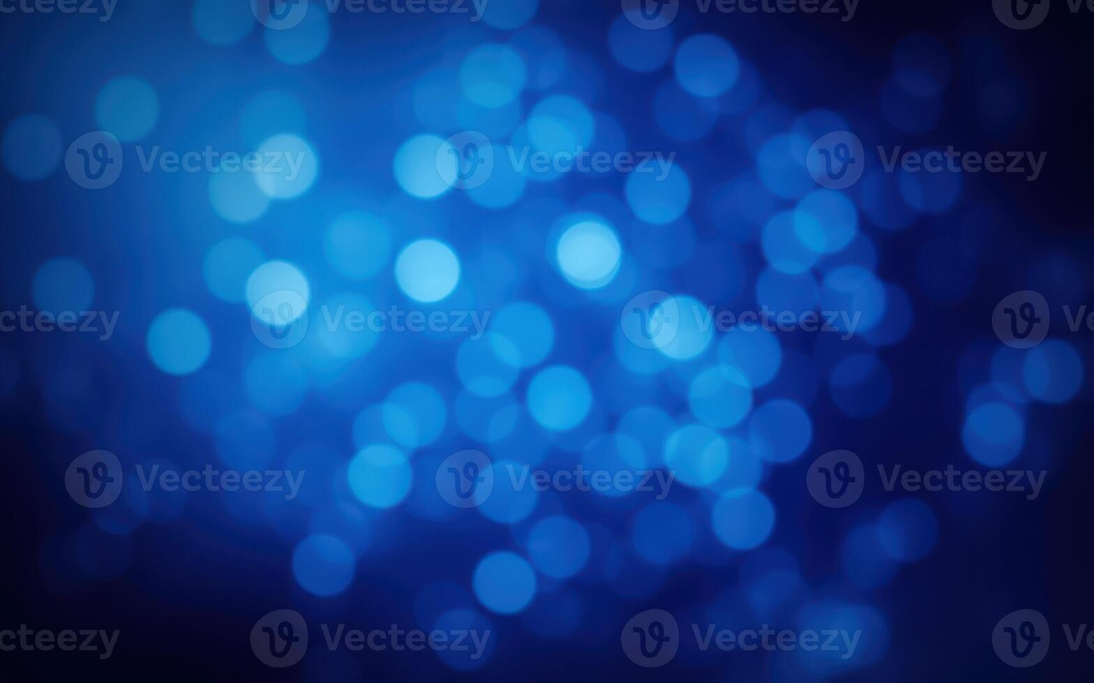 Colorful bokeh lights create a mesmerizing blue background during the evening hours photo