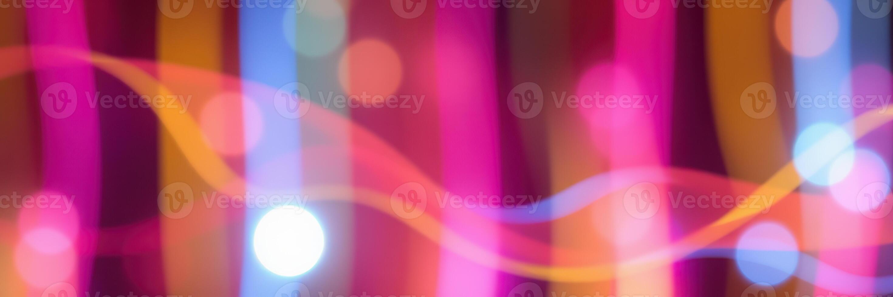 Vibrant abstract lights create a colorful display with flowing patterns and soft bokeh effects during a nighttime event photo