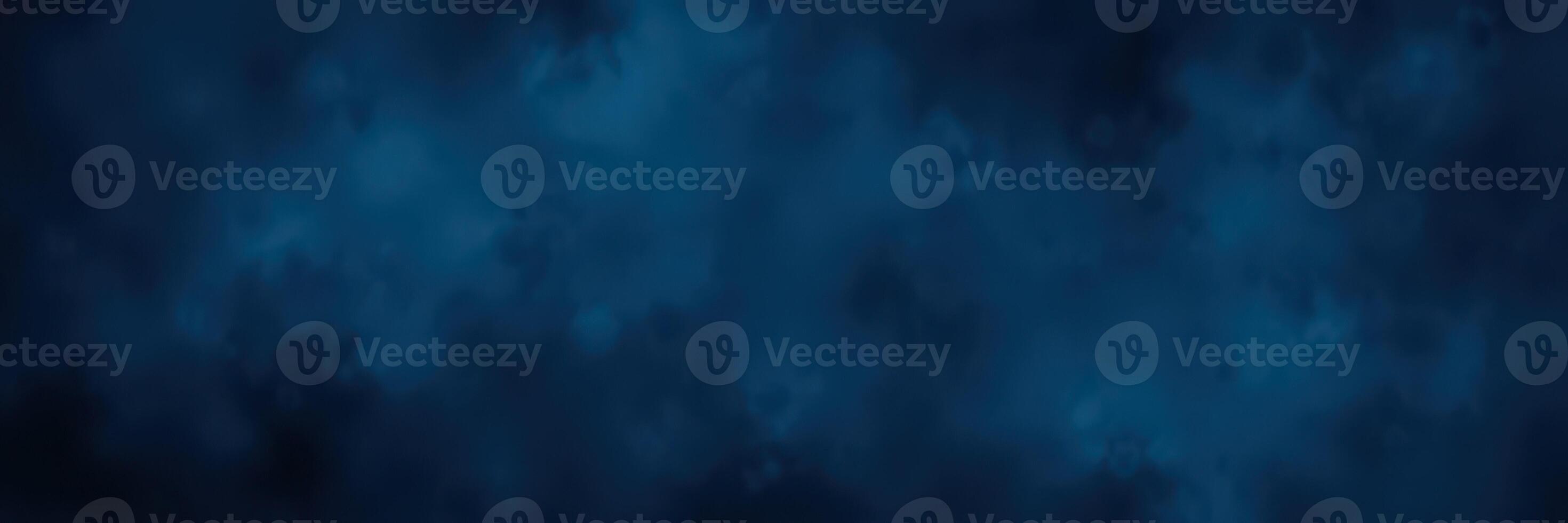 Night sky filled with swirling clouds and a deep blue backdrop creating a dramatic atmospheric effect photo