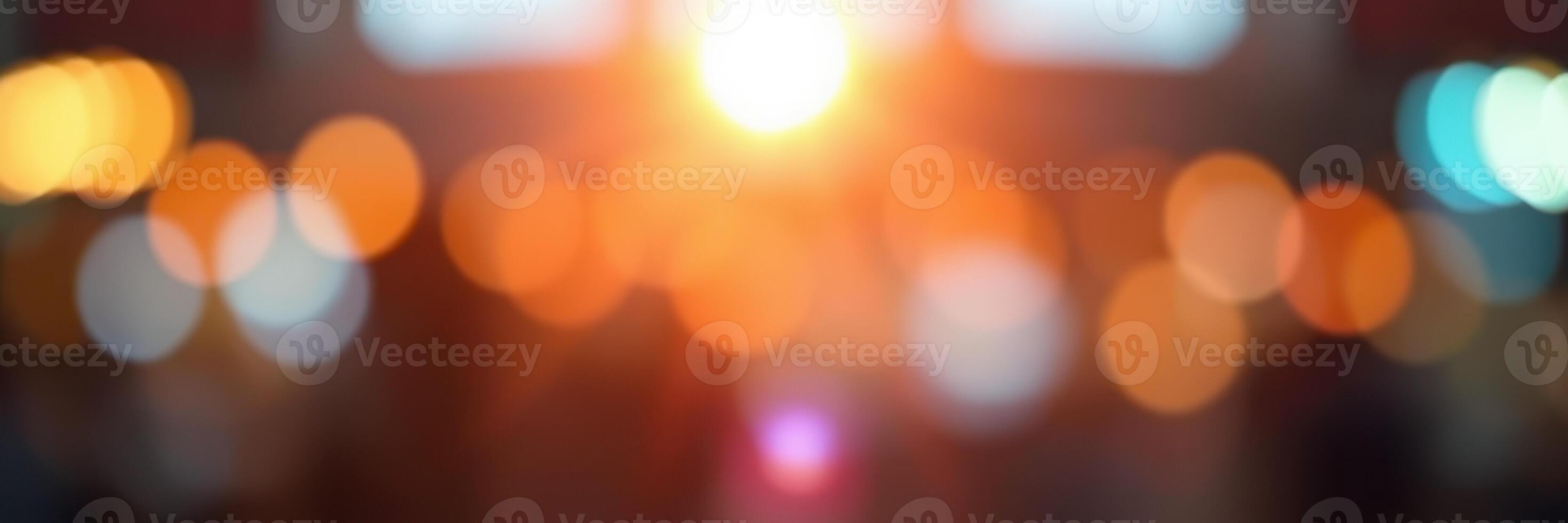 Beautiful sunset creates soft bokeh effect with vibrant orange and blue lights in urban setting during evening hours photo