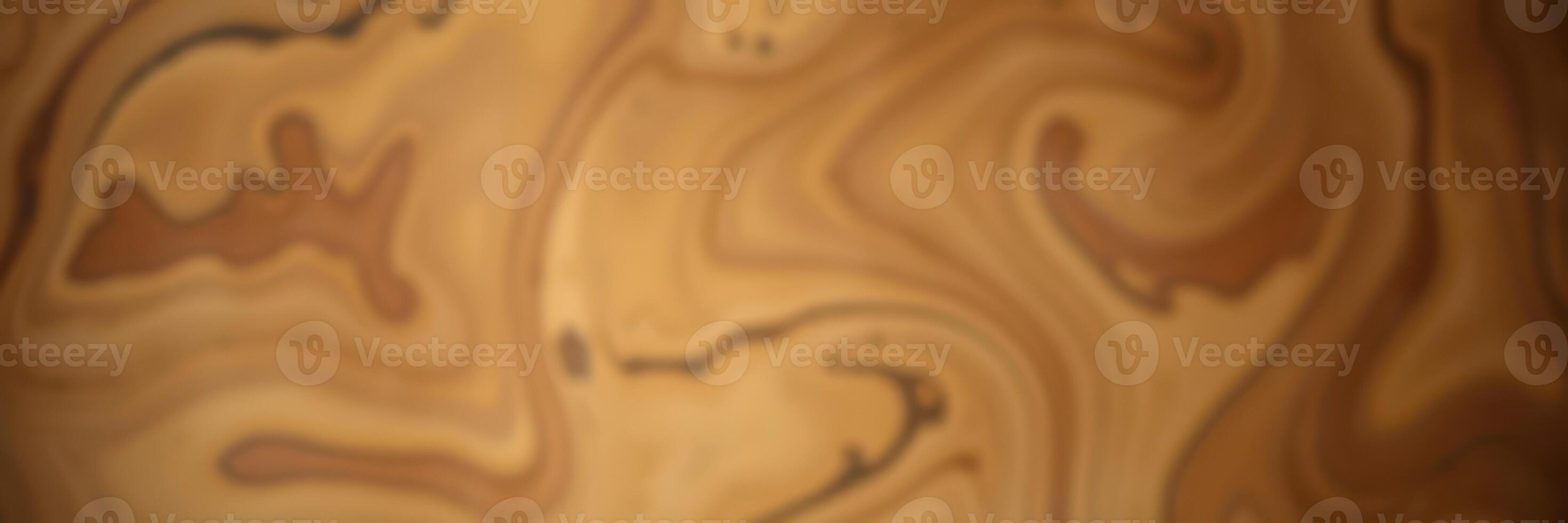 Swirling patterns of warm beige and brown create an abstract design reminiscent of natural wood grain photo