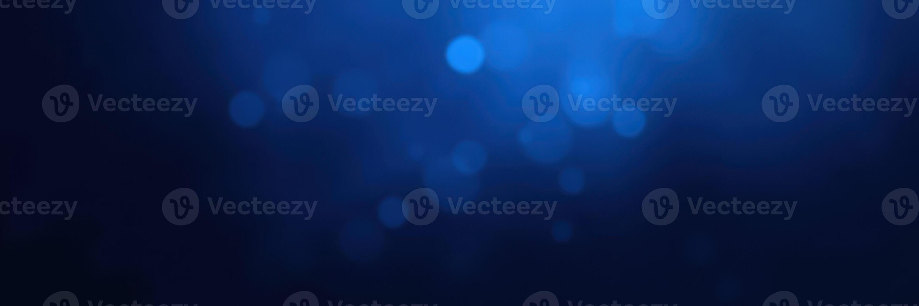 Deep blue background with soft bokeh lighting creating a serene and calming atmosphere photo