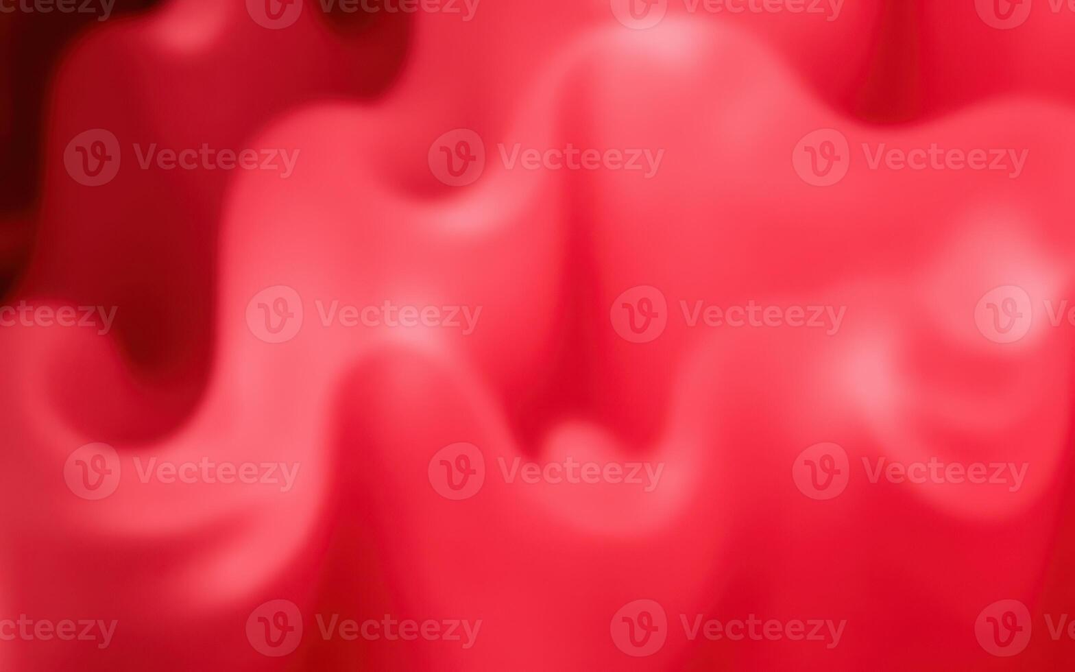 Textured waves of vibrant red curvatures create a sense of movement and energy resembling soft fabric draping elegantly photo