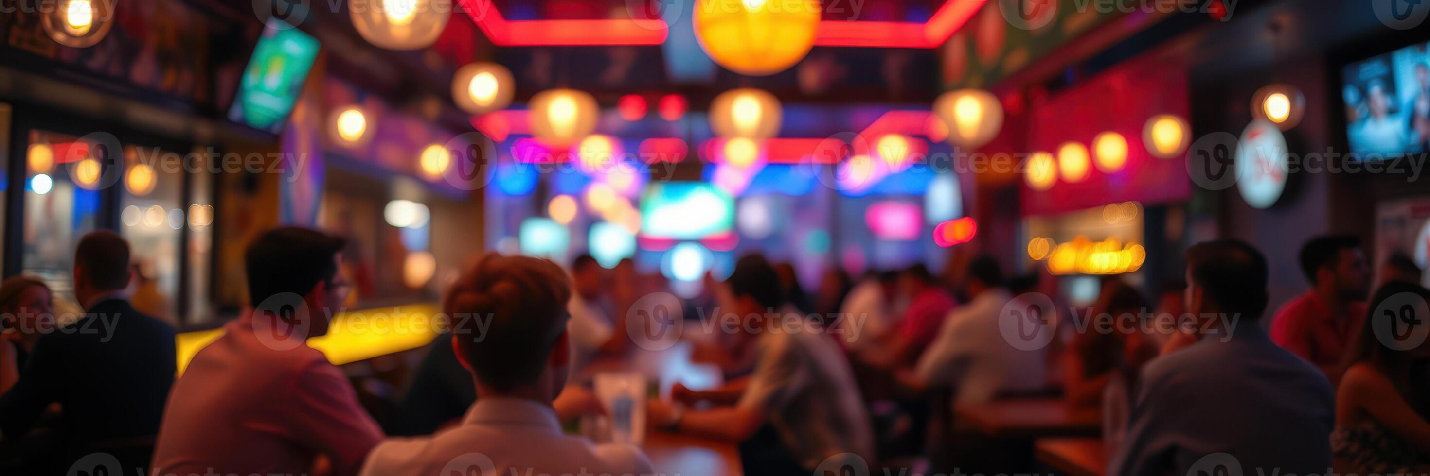 People socialize in a vibrant bar with colorful lights during an evening gathering in a lively urban area photo
