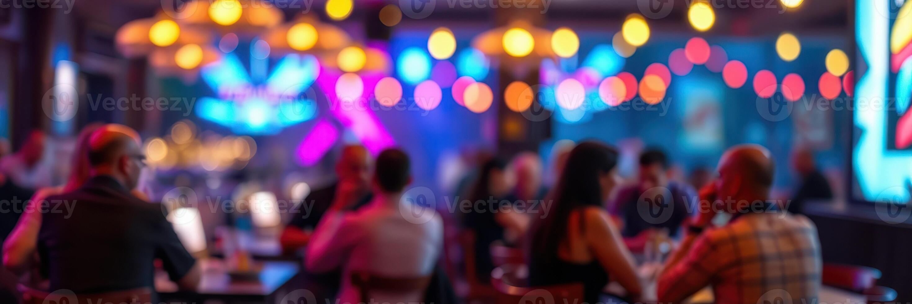 Social gathering in a vibrant bar with colorful lighting during evening hours photo