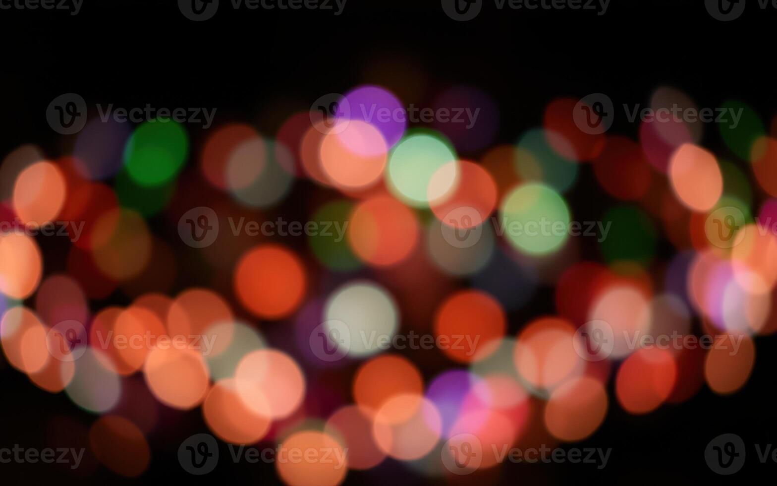Vibrant bokeh lights create a festive atmosphere during a nighttime celebration in a city park photo