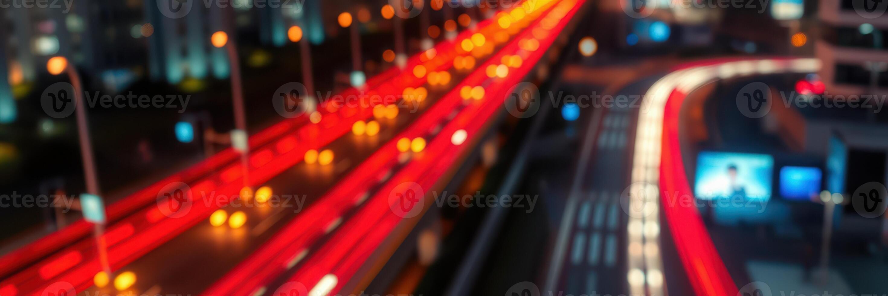 Nighttime city traffic illuminated by vibrant lights along a busy road in an urban setting photo