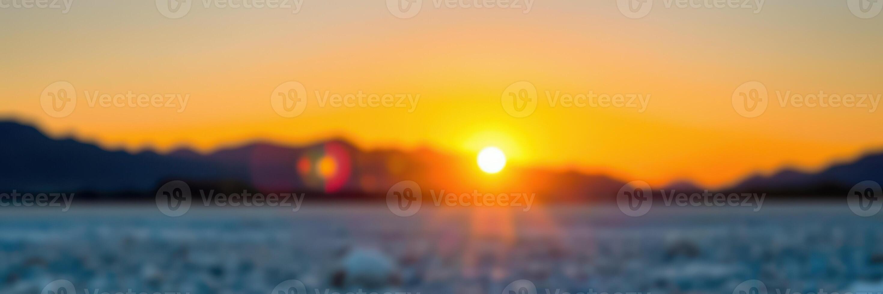 Sunset view over a tranquil body of water with distant mountains at twilight near a peaceful landscape photo