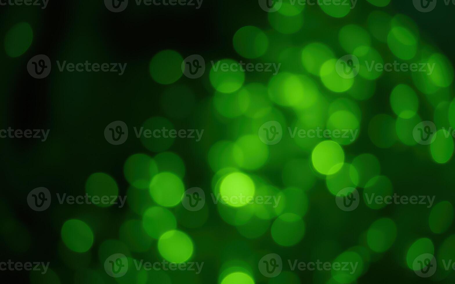 Vibrant green bokeh lights create a magical atmosphere in a nighttime setting filled with soft glimmering reflections photo