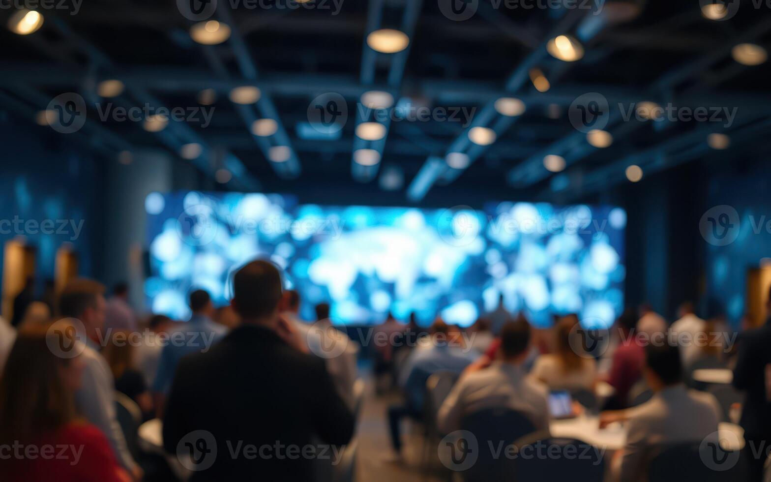 Professionals engage in networking during a technology conference at a modern venue in the evening photo