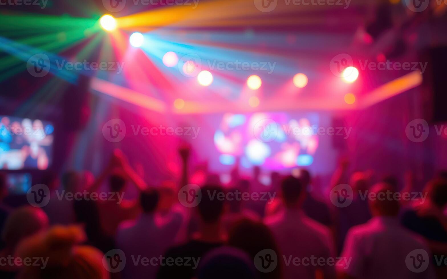 Colorful light display enhances lively atmosphere at concert with enthusiastic crowd interacting with performers photo