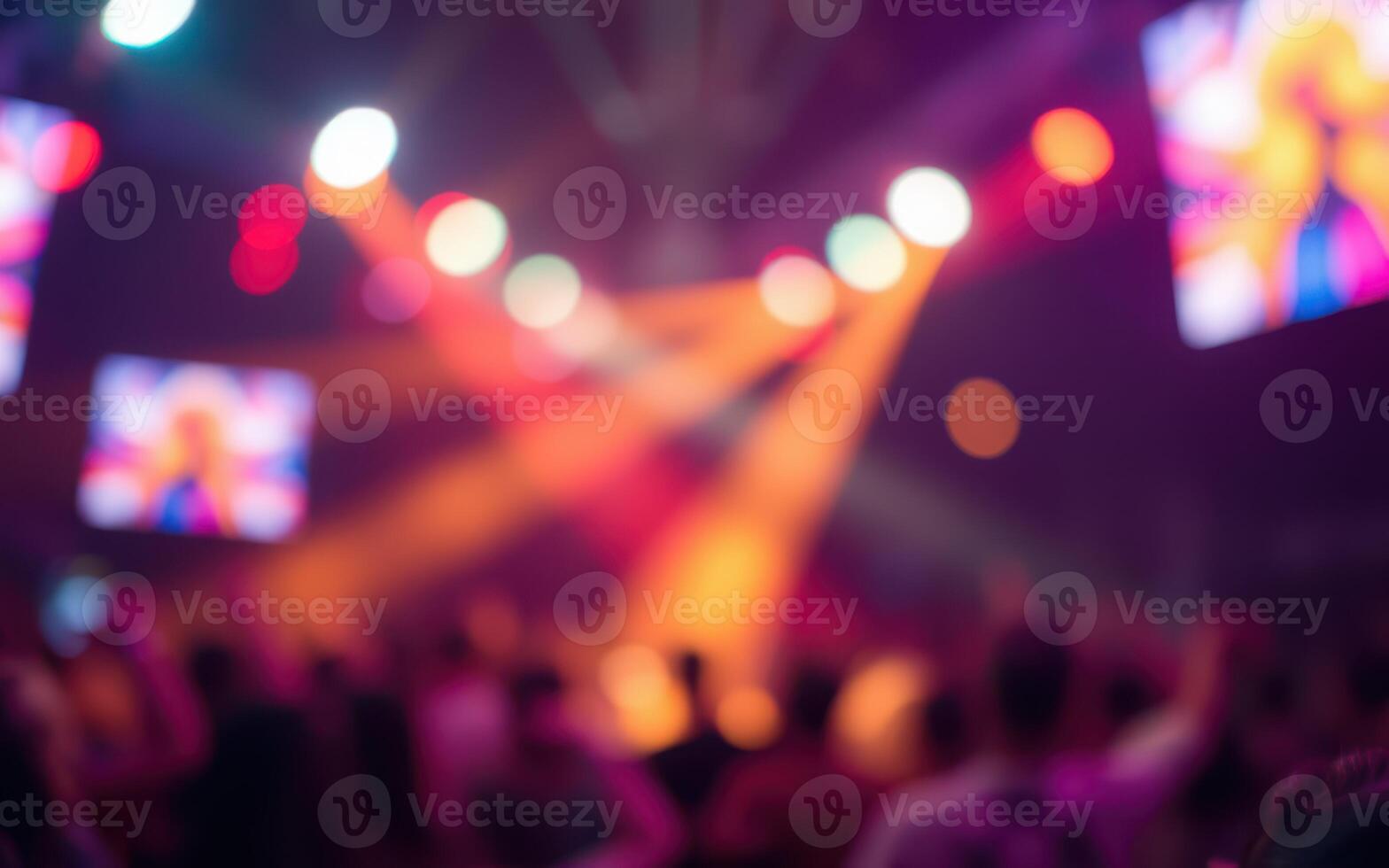Concert atmosphere filled with vibrant lights and a lively crowd enjoying a night of music and entertainment photo
