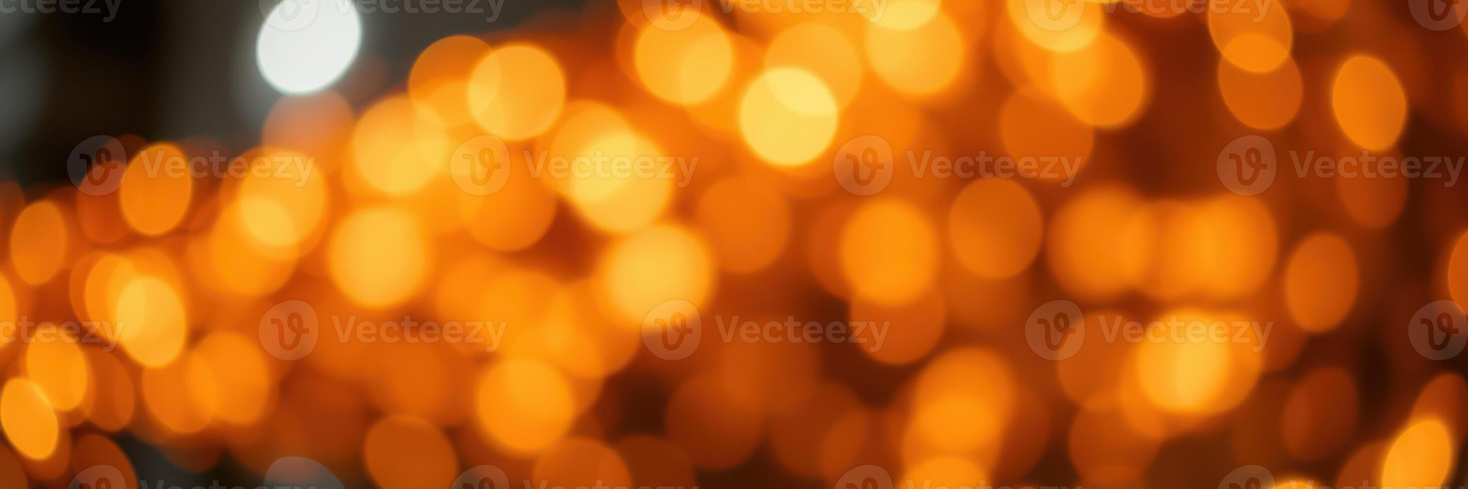 Bright orange bokeh lights create a warm atmosphere during an evening celebration in a festive location photo