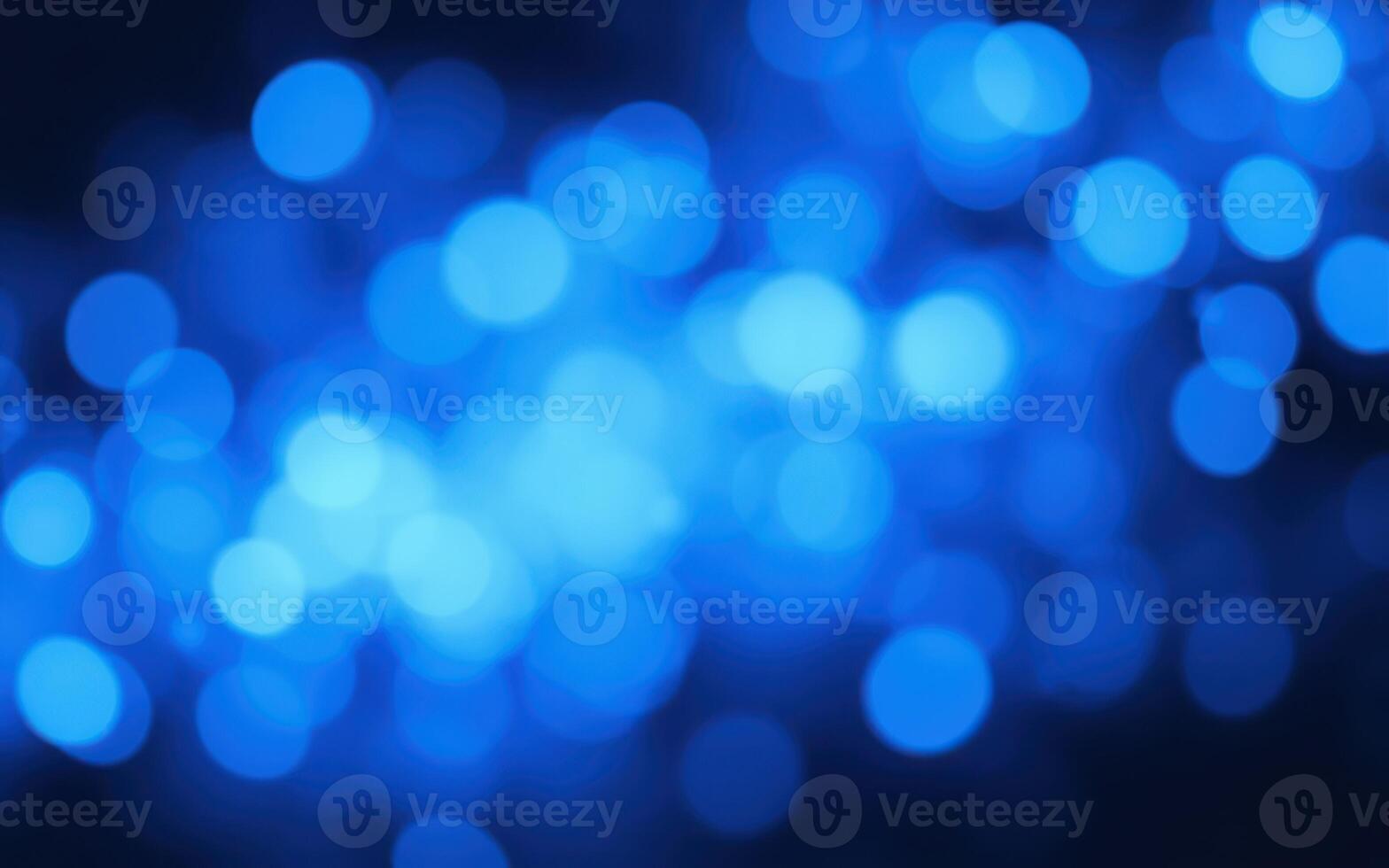 Vibrant blue bokeh creating an ethereal and dreamy atmosphere for artistic backgrounds and designs photo