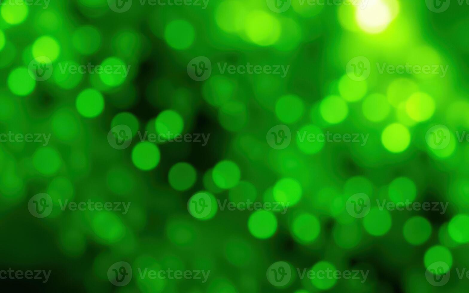 Vibrant green bokeh lights create a calming atmosphere in a natural setting during twilight hours photo