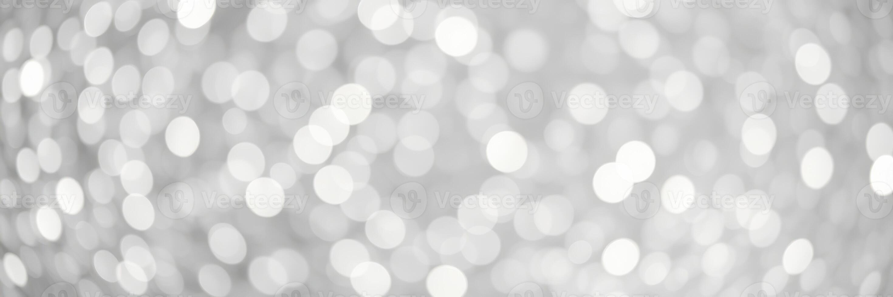 Soft white bokeh pattern creates a dreamy atmosphere suitable for various artistic projects or festive occasions photo