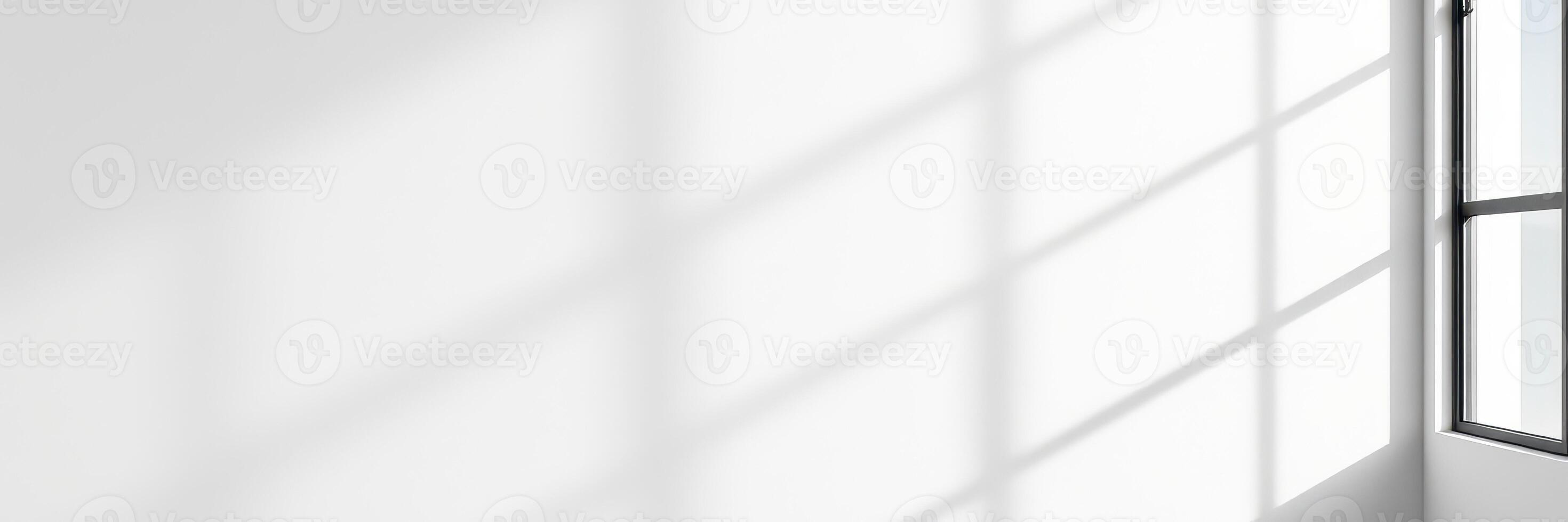 Natural light streaming through a window creating soft shadows in a minimalist interior space photo