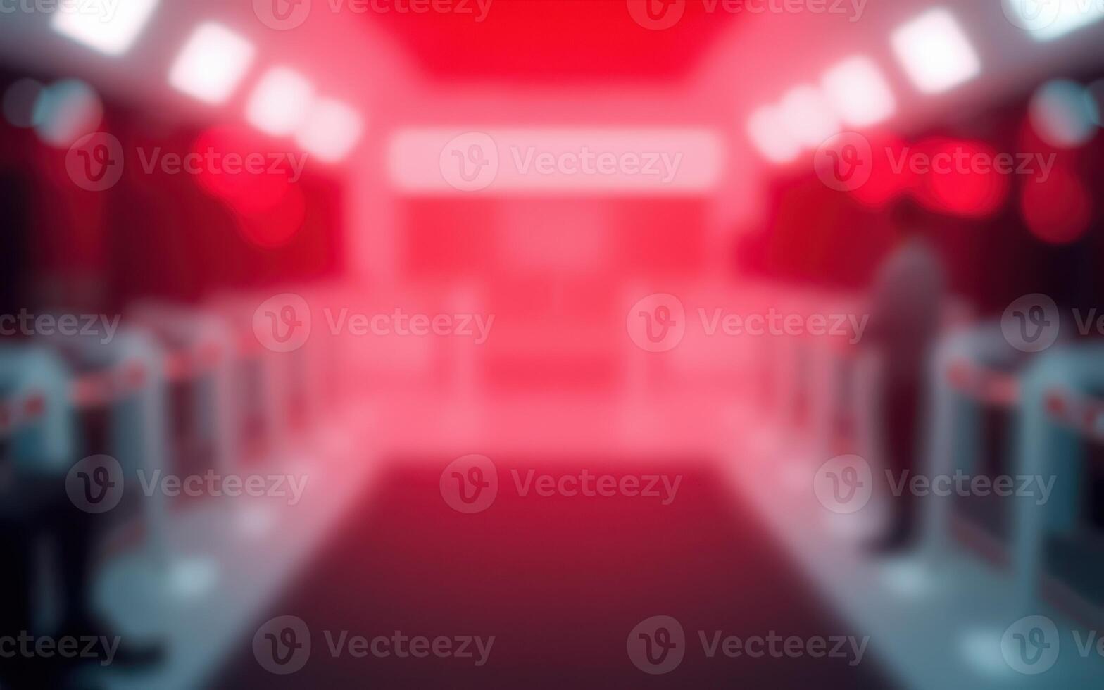 Red-lit futuristic train station with passengers waiting for departure during nighttime photo