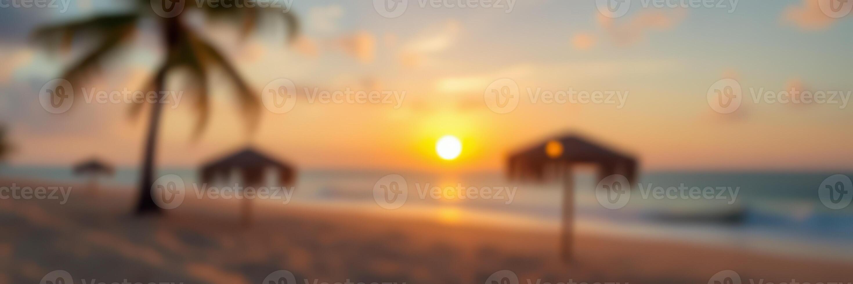 Majestic sunset over a serene beach with palm trees and umbrellas during golden hour photo
