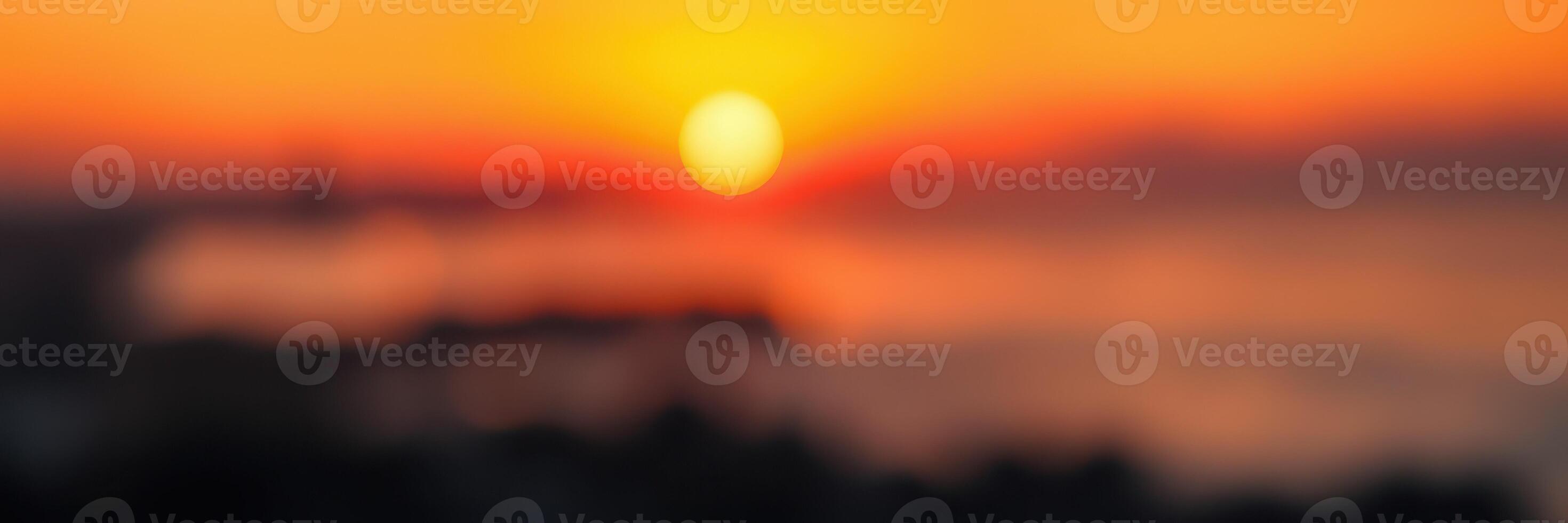 Vibrant sunset overlooking a serene ocean landscape during twilight hours on a warm evening photo