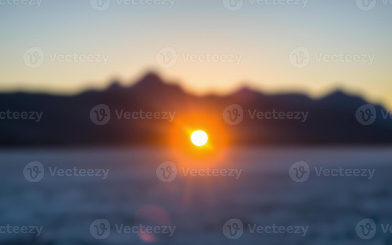 Sunset over the mountains with a blurred horizon and soft colors at dusk photo