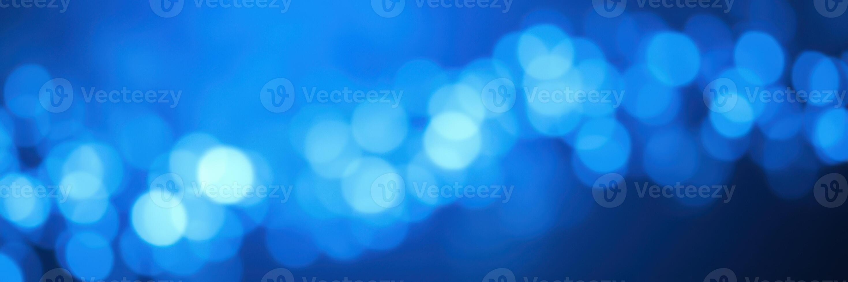 Soft blue bokeh lights create a calming atmosphere in an indoor setting during evening hours photo