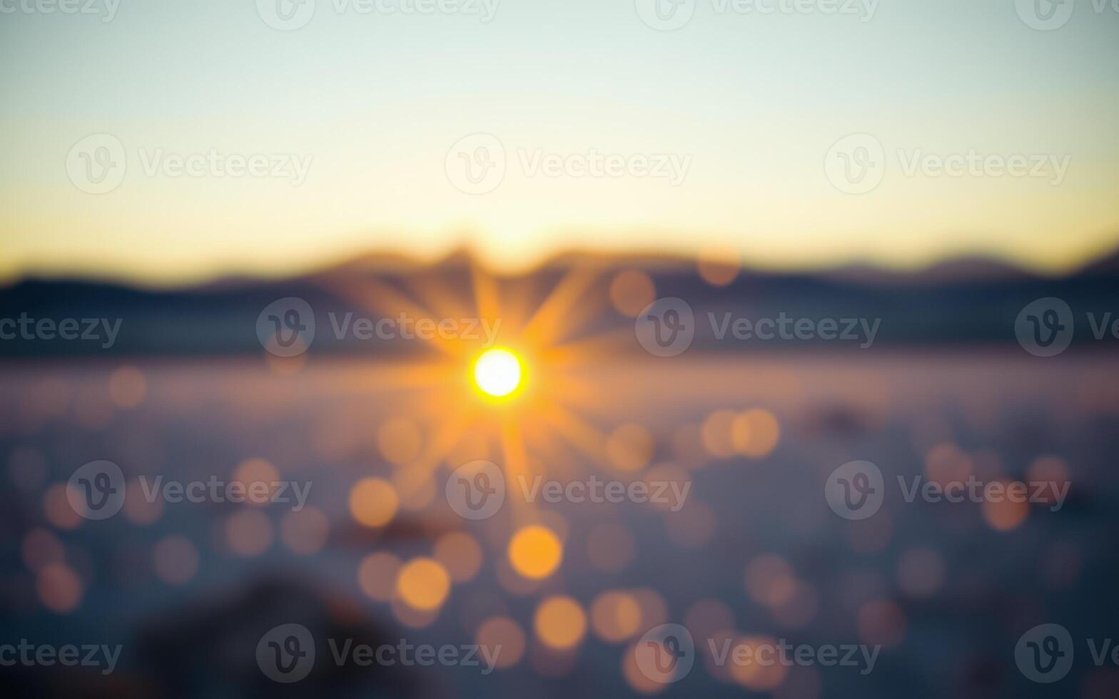 Sunrise illuminating a snowy landscape with blurred details and subtle bokeh effects at dawn photo