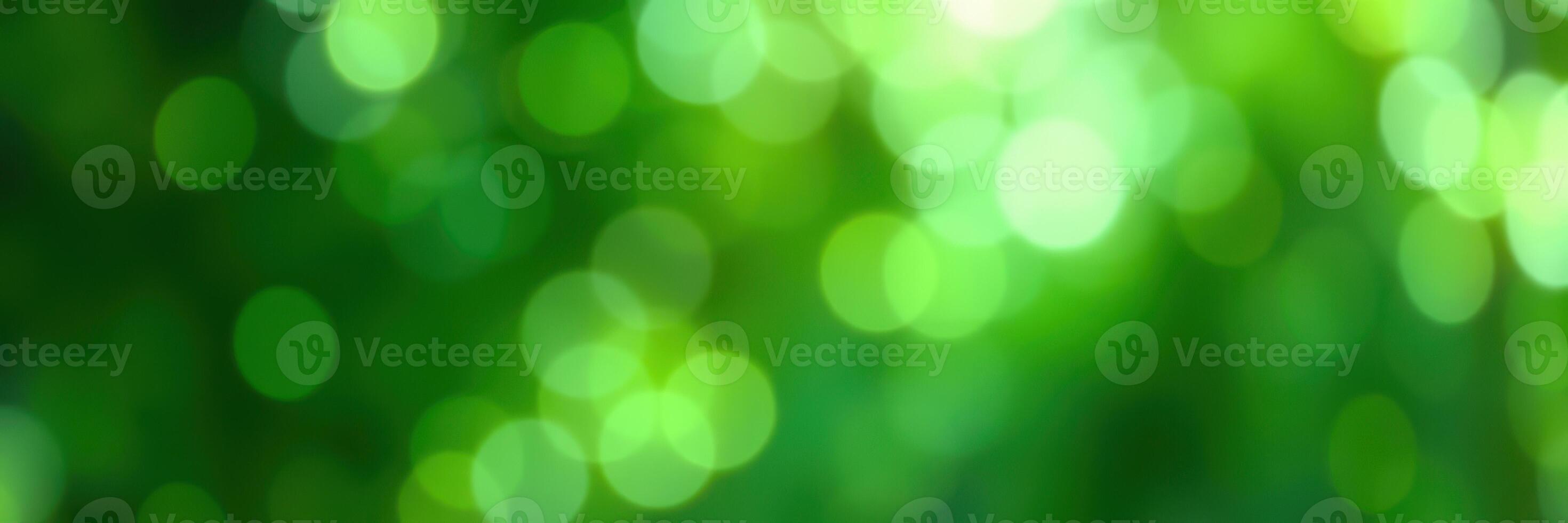 Beautiful green bokeh lights create a serene atmosphere in a fresh outdoor setting during a sunny day photo