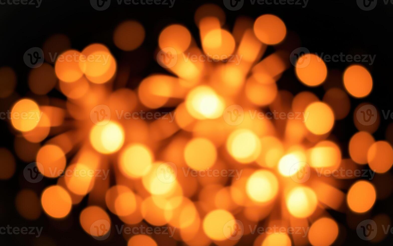 Bright orange firework display lighting up the night sky at a festive celebration in a vibrant setting photo