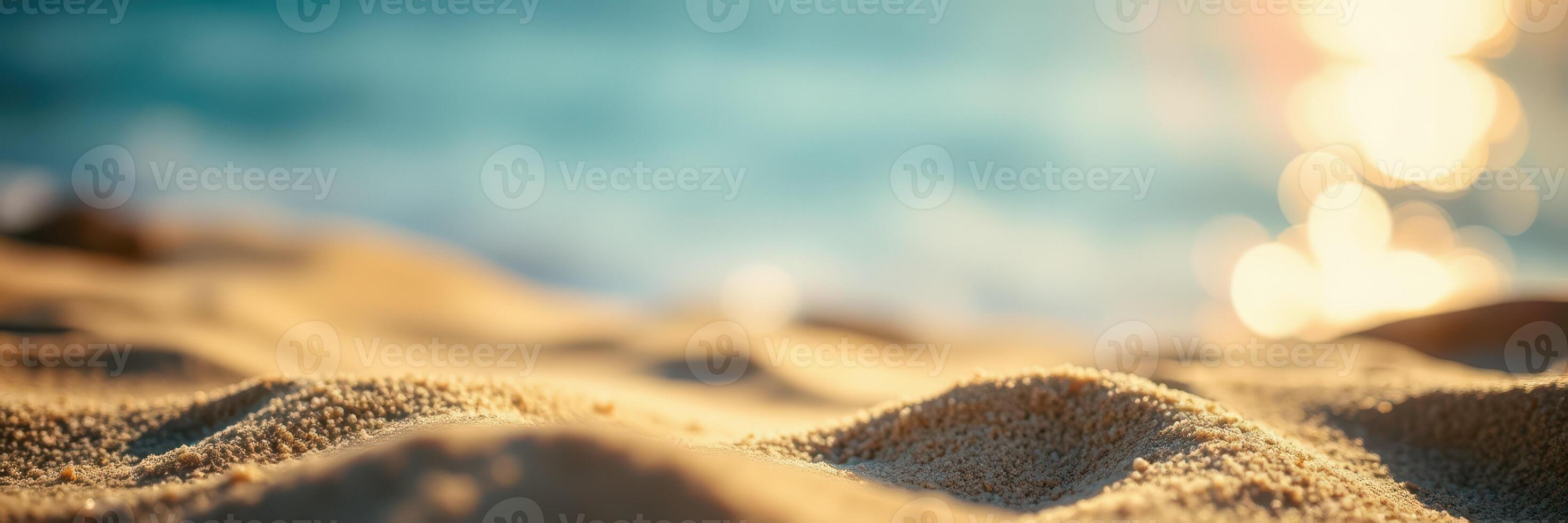Soft golden sand glistens under the sun by the tranquil ocean at sunset photo