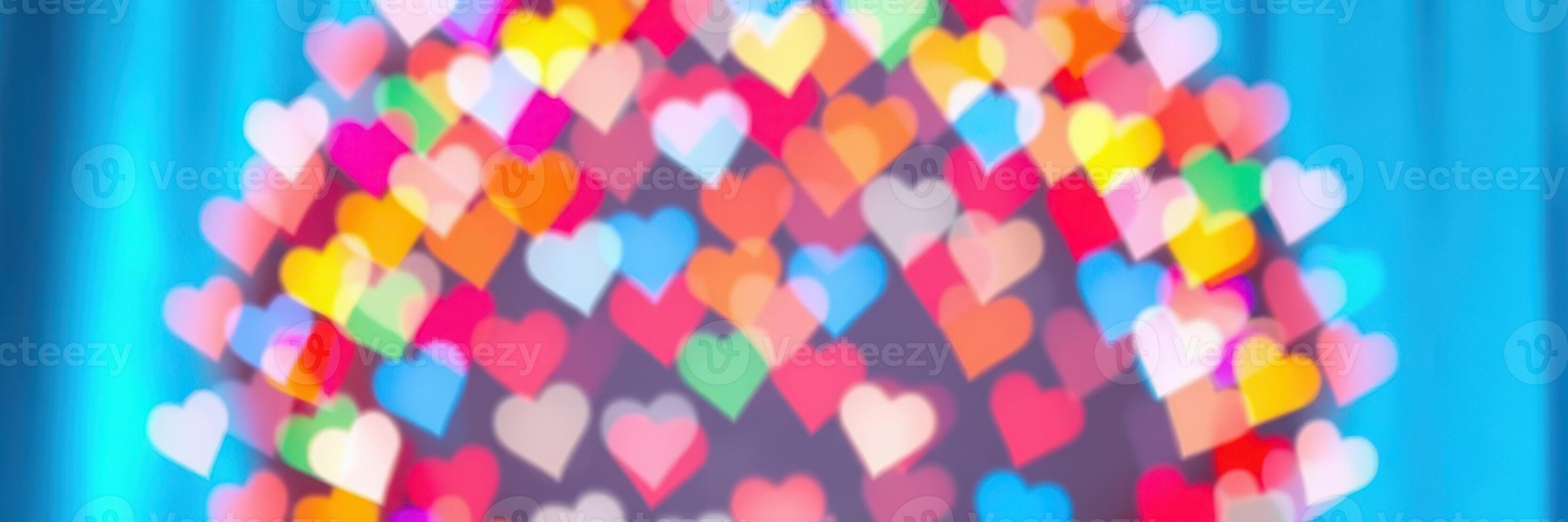 Colorful heart shapes illuminated against a blue background create a festive atmosphere for celebrations photo