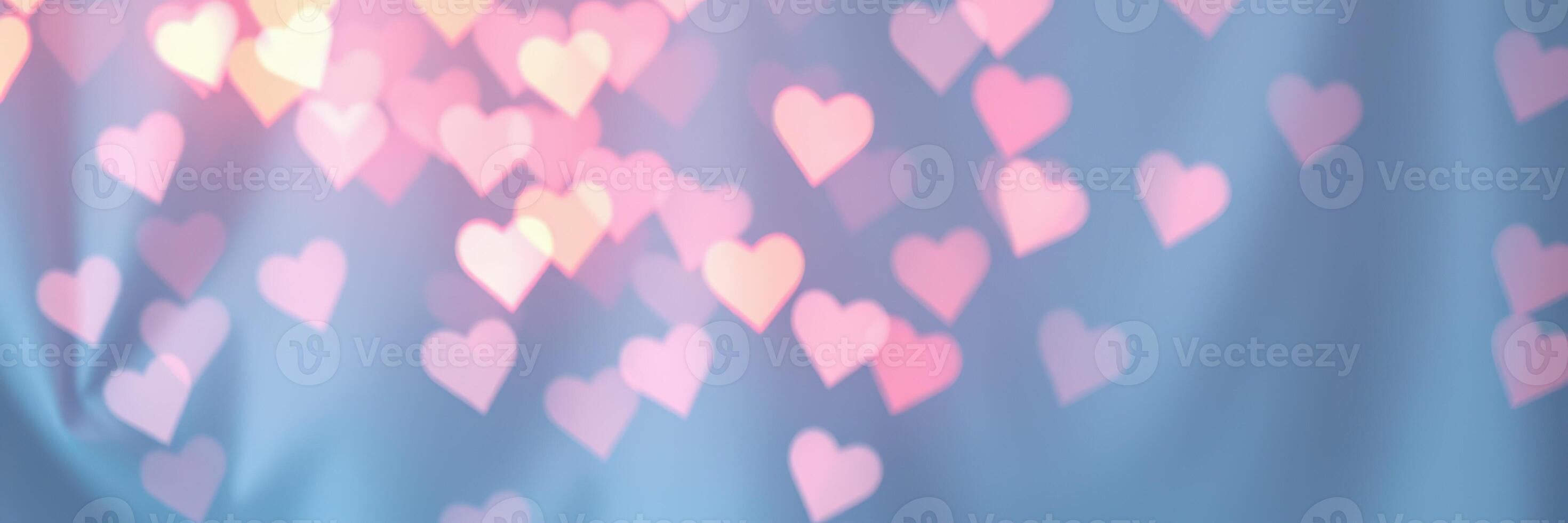 Colorful heart-shaped bokeh against a soft blue background creating a romantic atmosphere photo