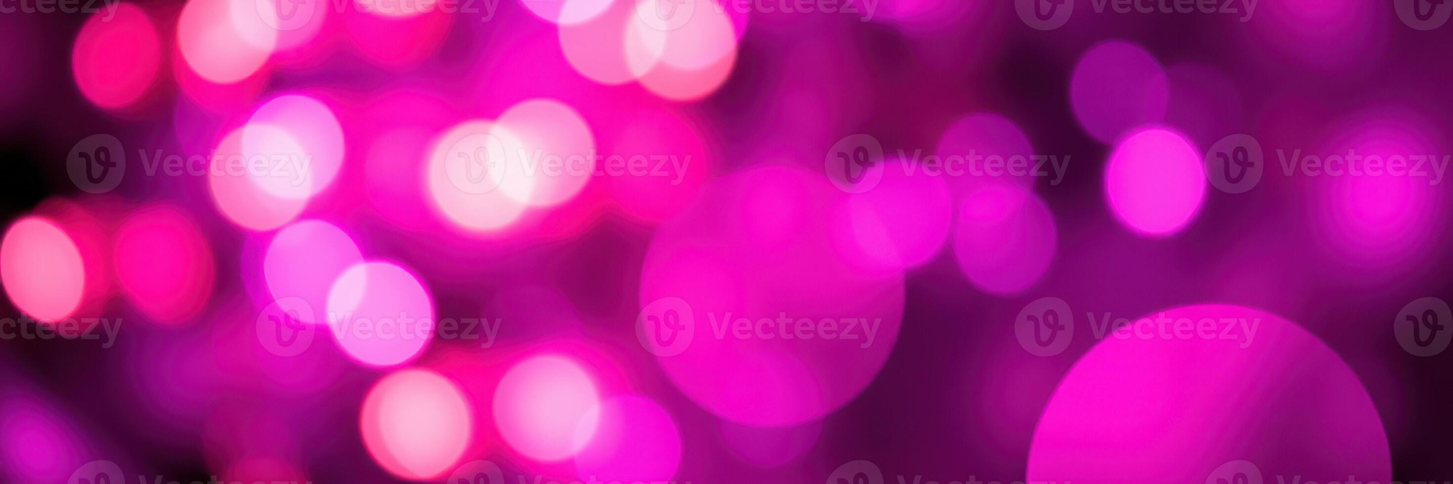 Colorful bokeh lights create a visually stunning background in shades of pink and purple at a nighttime celebration photo