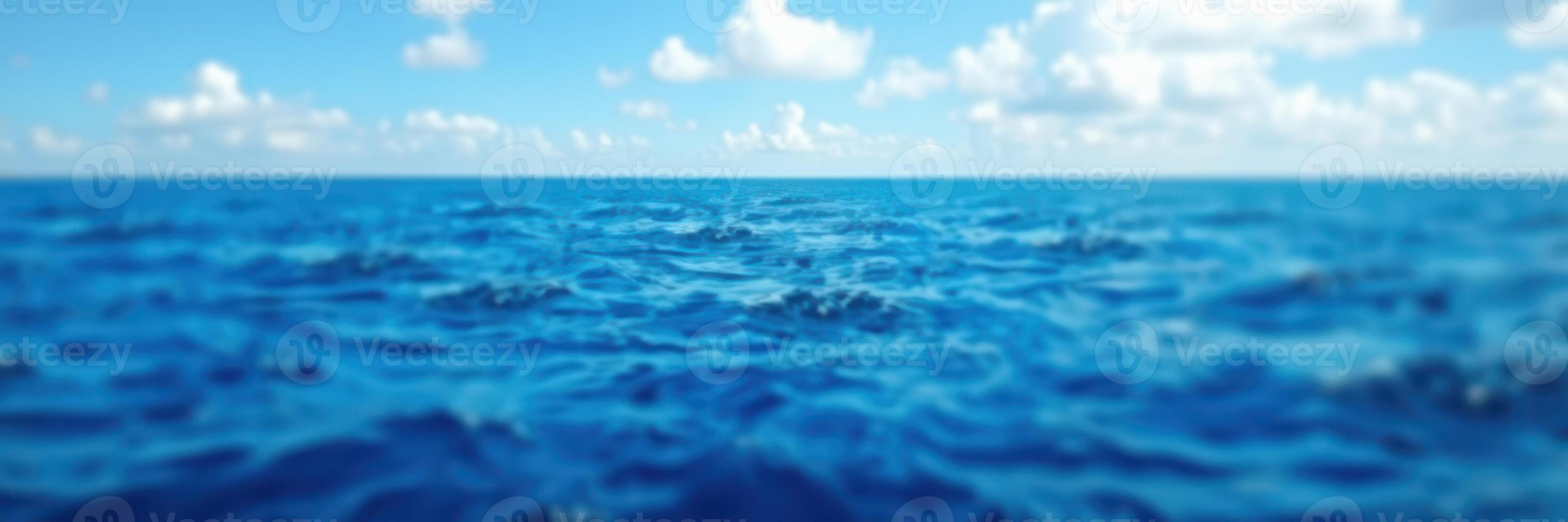 Tranquil ocean view under a vivid blue sky with soft clouds on a sunny day photo