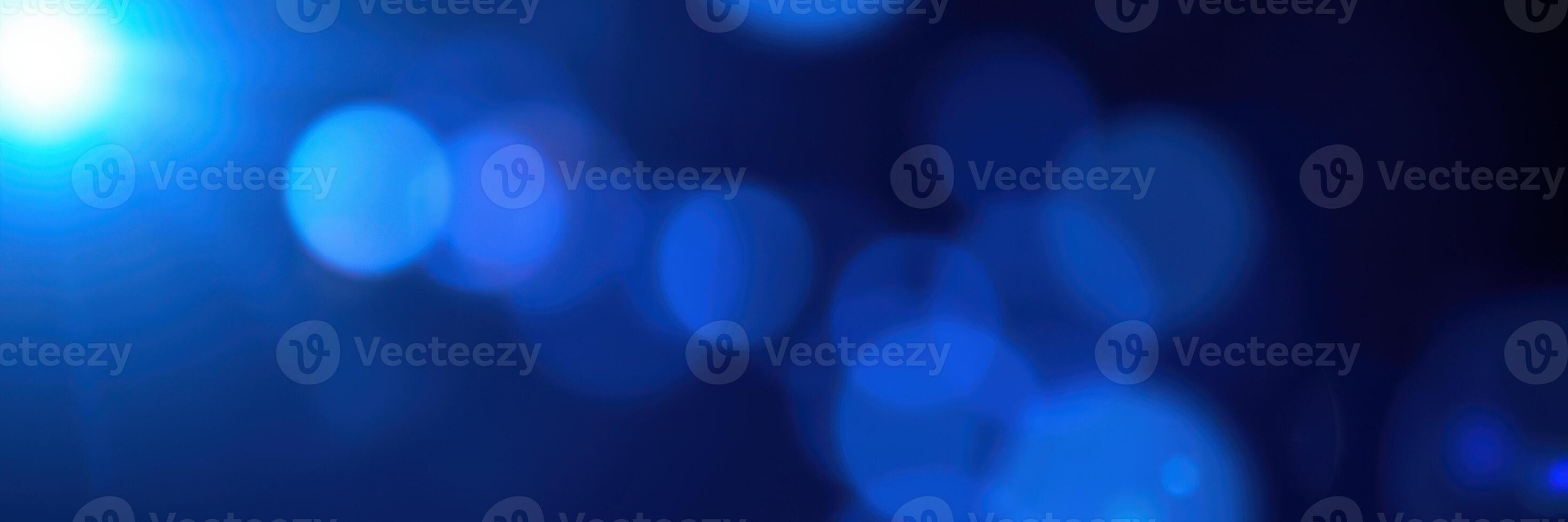 Abstract blue bokeh lights create a dreamy atmosphere in a dimly lit space with an enchanting glow photo