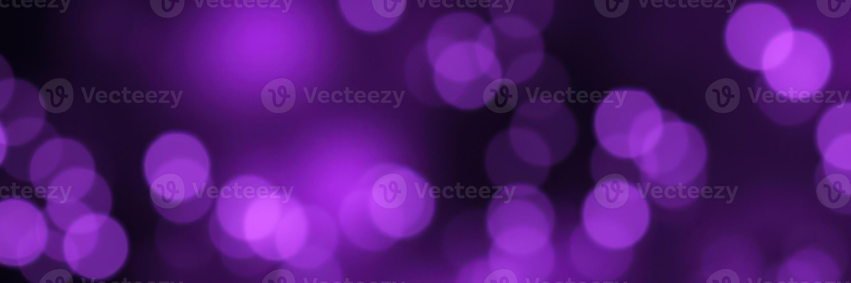 Vibrant purple bokeh lights create a dreamy atmosphere at an evening event photo