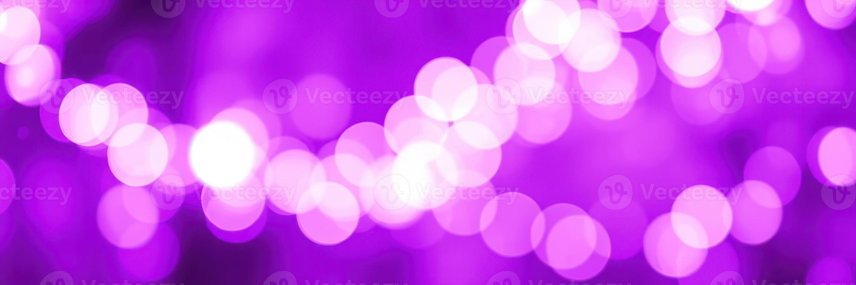 Purple bokeh lights create a magical atmosphere during an evening celebration in an urban setting photo