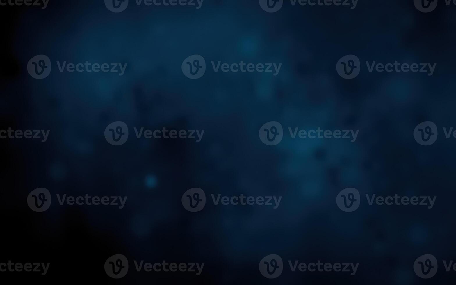 Dark blue abstract background with soft glowing light, creating a serene and tranquil atmosphere photo