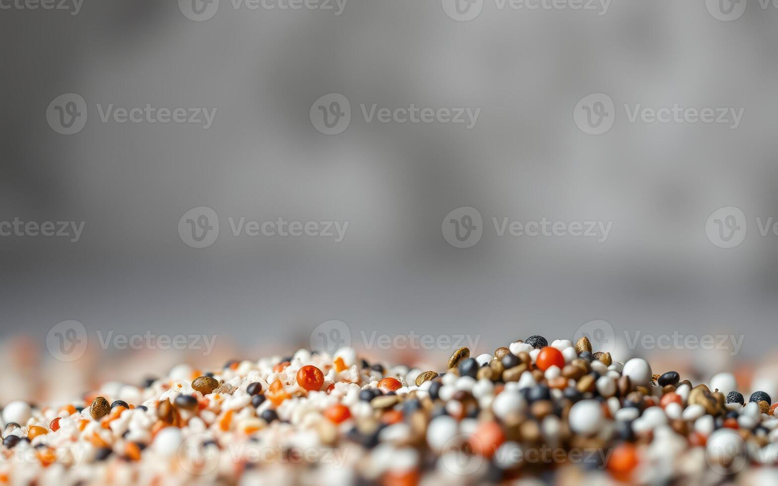 Colorful assortment of grains and seeds arranged on a surface in a bright setting highlighting texture and variety of colors photo