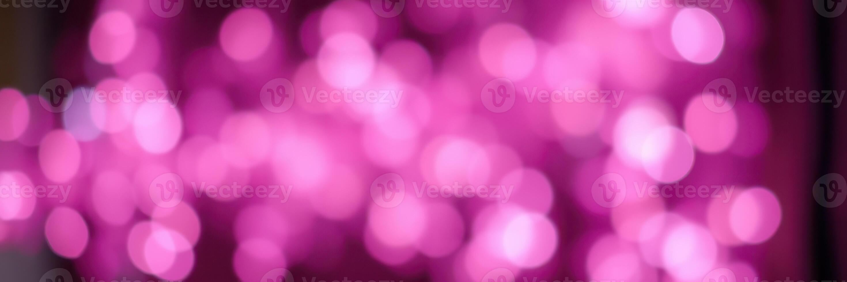 Vibrant pink bokeh lights create a dreamy atmosphere during a festive celebration at night photo