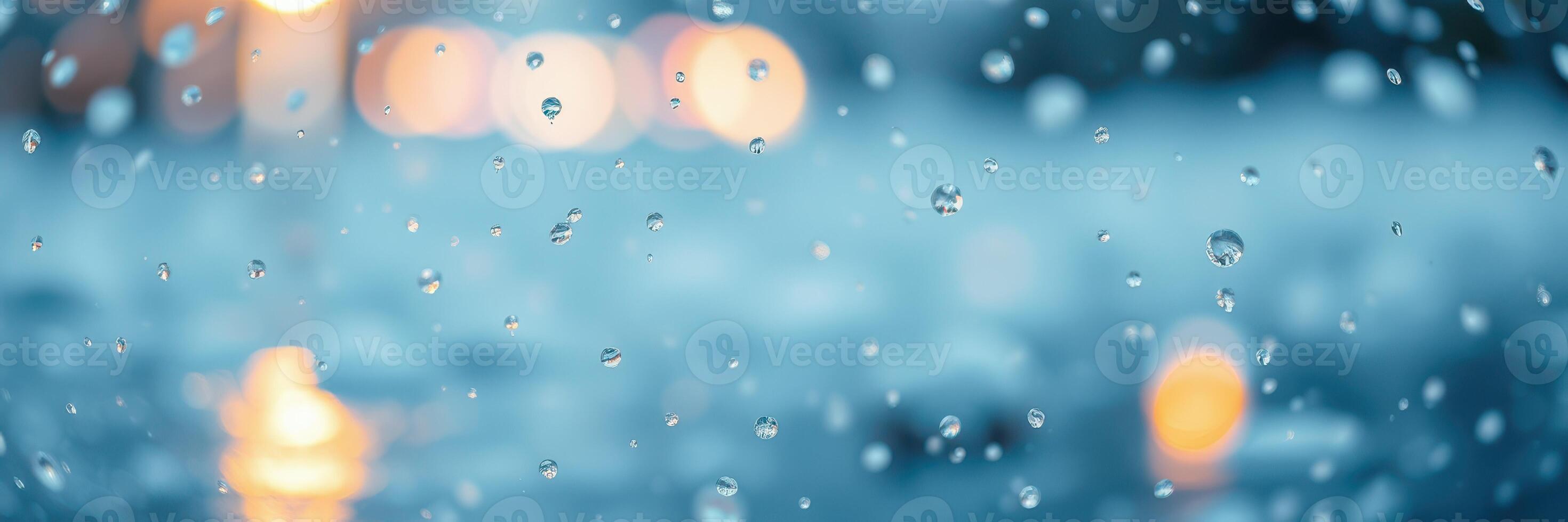 Raindrops create a mesmerizing pattern on a window during a rainy evening in the city photo