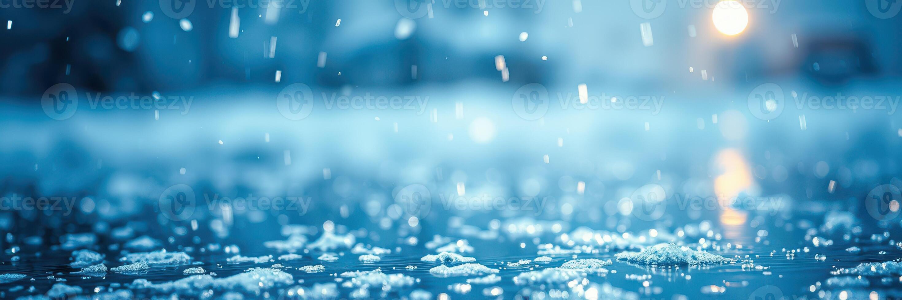 Raindrops fall onto a serene surface creating ripples in a blue-tinted environment during a calm evening photo