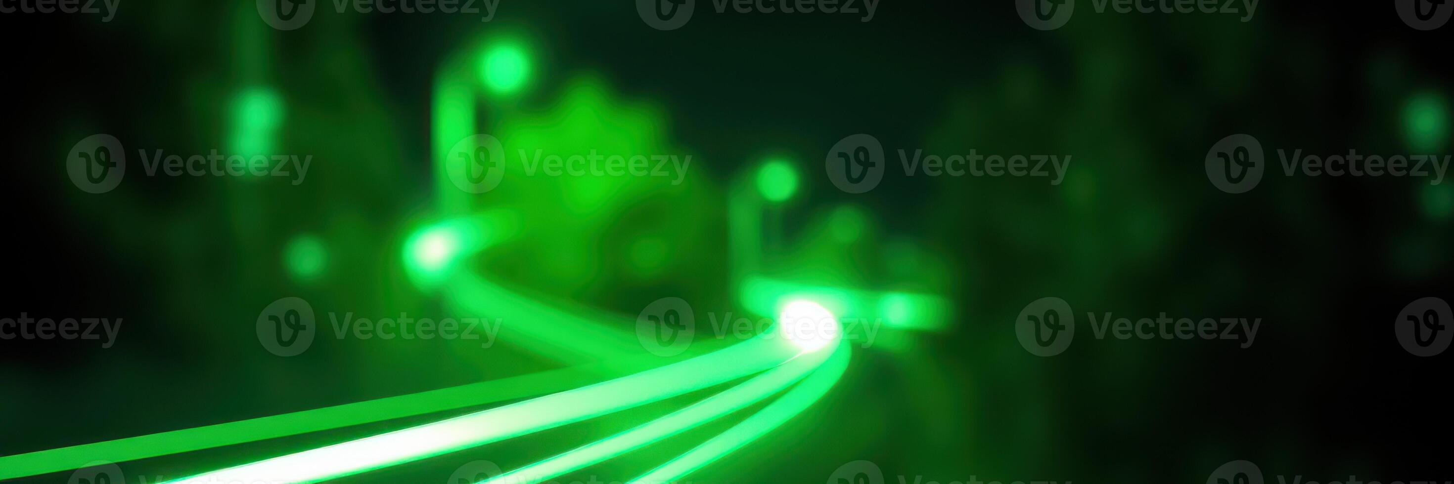 Green light trails illuminate a winding path in a nighttime urban setting photo