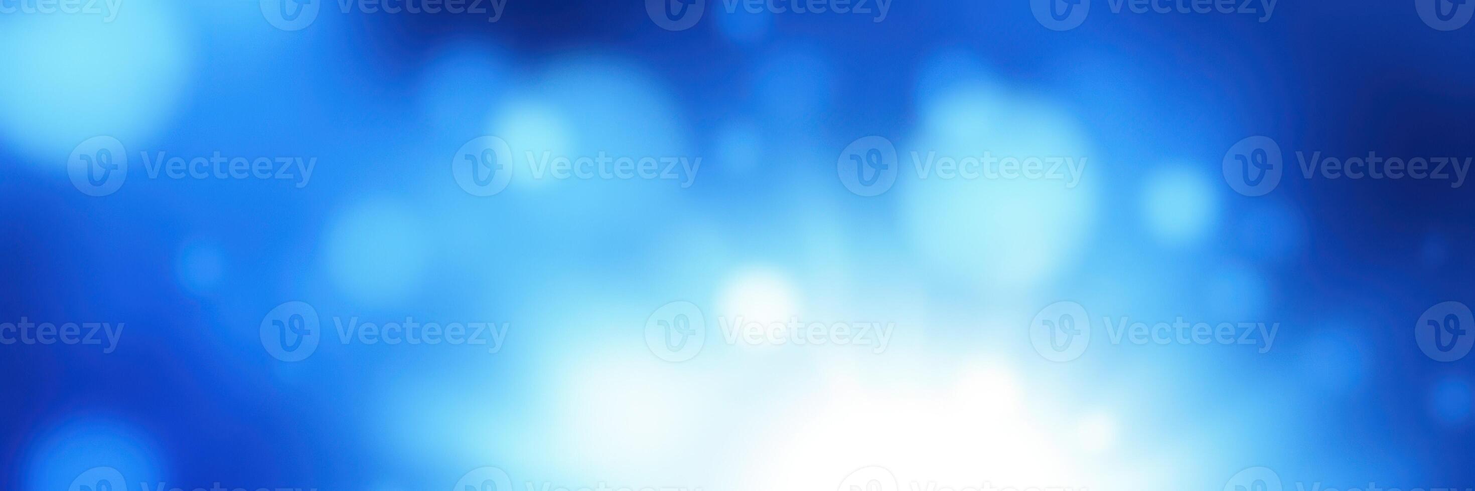 Vibrant blue abstract background featuring soft glowing bokeh lights creating a serene atmosphere photo