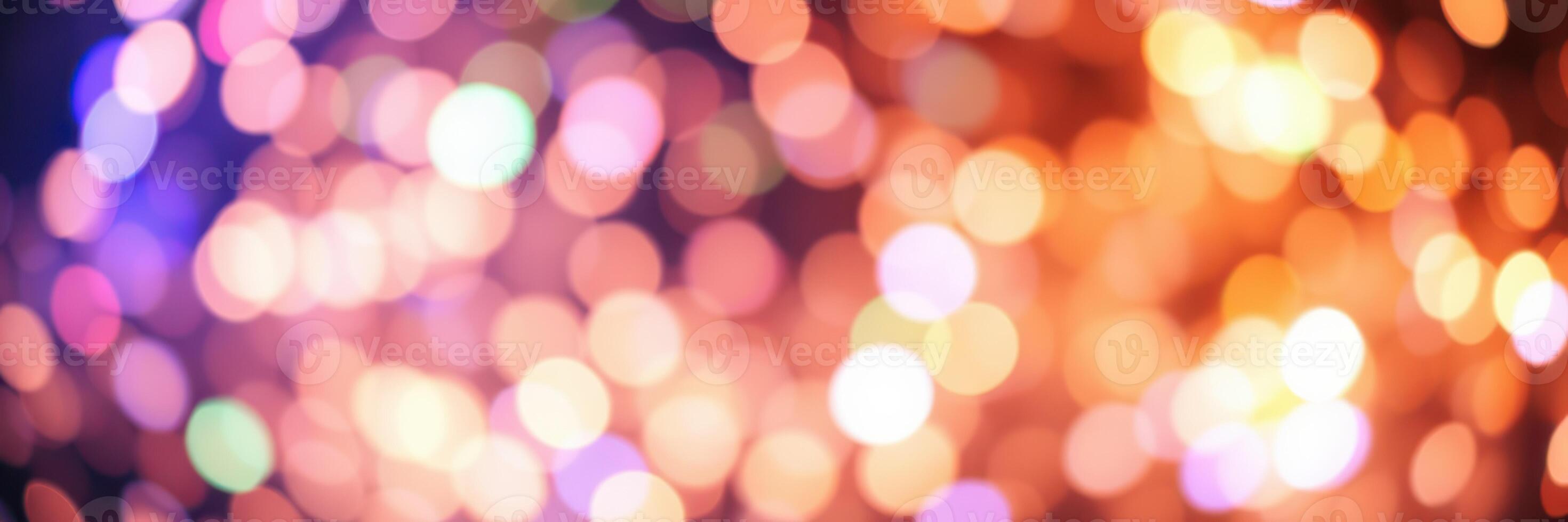 Colorful bokeh lights create a festive atmosphere during a nighttime celebration in a lively city photo