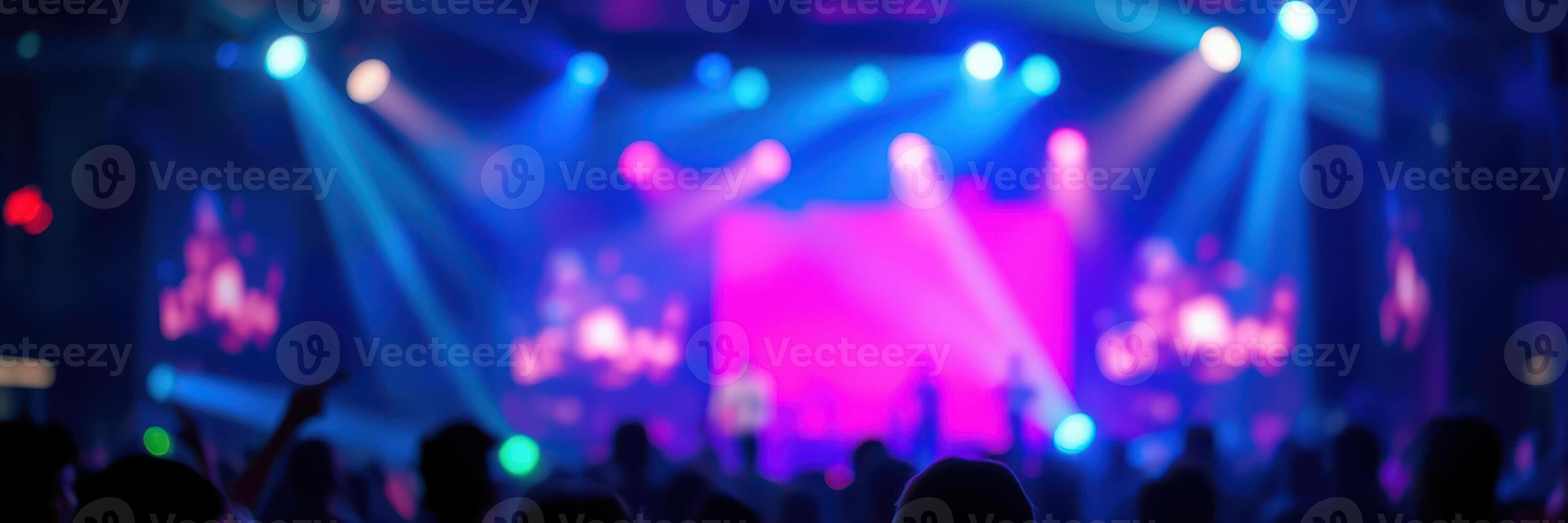 Colorful lights illuminate concert crowd during vibrant music show in urban venue photo