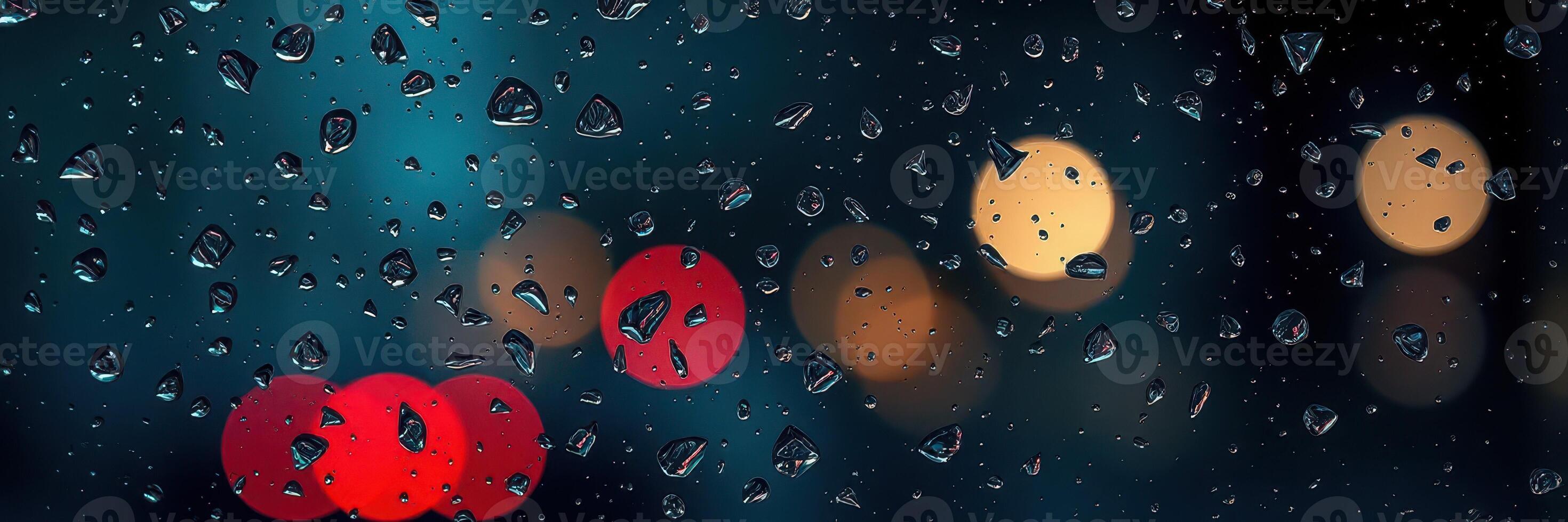 Raindrops on a window create a blurred view of city lights at night during a rainy evening photo